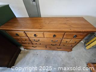 MaxSold Auction: Solid Pine Lowboy Dresser, 12 Drawers, Honey-Brown Finish - Chesapeake (Virginia, USA) PARTNER MANAGED Downsizing Online Auction - River Arch Drive