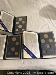 MaxSold Auction: Set of 3 Royal Canadian Mint Coin Sets  - Victoria (British Columbia, Canada) SELLER MANAGED Moving Online Auction - Toronto Street