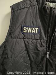 MaxSold Auction: Black SWAT costume vest, size XL, with patches and toy police badge. Good condition - Vancouver (British Columbia, Canada) SELLER MANAGED Reseller Online Auction - East 7th Avenue (STORAGE)