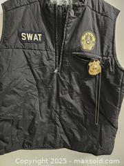 MaxSold Auction: Black SWAT costume vest, size XL, with patches and toy police badge. Good condition - Vancouver (British Columbia, Canada) SELLER MANAGED Reseller Online Auction - East 7th Avenue (STORAGE)