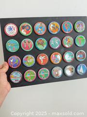 MaxSold Auction: Collection of 1984 Olympic buttons mounted on black cardboard - Vancouver (British Columbia, Canada) SELLER MANAGED Reseller Online Auction - Main Street