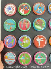MaxSold Auction: Collection of 1984 Olympic buttons mounted on black cardboard - Vancouver (British Columbia, Canada) SELLER MANAGED Reseller Online Auction - Main Street