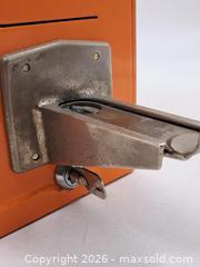 MaxSold Auction: Vintage Orange Coin-Operated Drop Bank with Lever - Victoria (British Columbia, Canada) PARTNER MANAGED Estate Sale Online Auction - Hillside Avenue