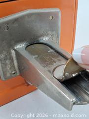 MaxSold Auction: Vintage Orange Coin-Operated Drop Bank with Lever - Victoria (British Columbia, Canada) PARTNER MANAGED Estate Sale Online Auction - Hillside Avenue