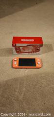 MaxSold Auction: Nintendo Switch Lite  Coral color.  - Toronto (Ontario, Canada) SELLER MANAGED Downsizing Online Auction -  Pilkington Drive