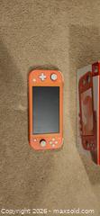 MaxSold Auction: Nintendo Switch Lite  Coral color.  - Toronto (Ontario, Canada) SELLER MANAGED Downsizing Online Auction -  Pilkington Drive