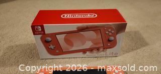 MaxSold Auction: Nintendo Switch Lite  Coral color.  - Toronto (Ontario, Canada) SELLER MANAGED Downsizing Online Auction -  Pilkington Drive