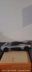 MaxSold Auction: Aston Martin Valkyrie 1:18 Static Model Car, Silver/Black/Orange - Toronto (Ontario, Canada) SELLER MANAGED Downsizing Online Auction - Wilson Avenue (CONDO)