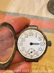MaxSold Auction: Vintage WWI-Era Trench Watch with Hinged Case & Military Inscription – Approx. 32–33mm  - Toronto (Ontario, Canada) SELLER MANAGED Moving Online Auction - 1/2  Wellesley Street East