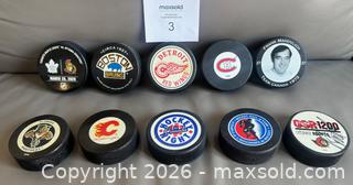 MaxSold Auction: Lot of 10 Hockey Pucks w / Game  & Commerative Pucks ++ - Ottawa (Ontario, Canada) SELLER MANAGED Downsizing Online Auction - Sandy Forest Place