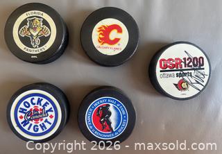 MaxSold Auction: Lot of 10 Hockey Pucks w / Game  & Commerative Pucks ++ - Ottawa (Ontario, Canada) SELLER MANAGED Downsizing Online Auction - Sandy Forest Place