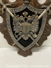 MaxSold Auction: Decorative Wall Plaque with Swords & Double-Headed Eagle Crest (Approx. 32”) - Vancouver (British Columbia, Canada) SELLER MANAGED Reseller Online Auction - East 7th Avenue (STORAGE)