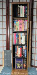 MaxSold Auction: Lot of ~34 VHS Tapes with Oak-Look Vertical Storage Shelf - Warwick (Rhode Island, USA) SELLER MANAGED Reseller Online Auction - Warwick Avenue
