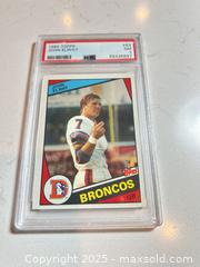 MaxSold Auction: 1984 Topps #63 JOHN ELWAY Graded PSA 7 ROOKIE CARD NM - Denver Broncos Hall of Famer! - Parker (Colorado, USA) SELLER MANAGED Commercial Liquidation Online Auction - Heritage Oak Drive