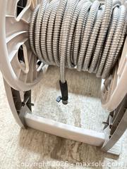 MaxSold Auction: Garden hose on wheeled reel with flexible metal-wrapped hose A - Ottawa (Ontario, Canada) PARTNER MANAGED Downsizing Online Auction - Sablewood Place