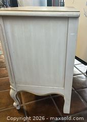 MaxSold Auction: Furniture Duo: White 2-Drawer Nightstand & Ornate Wooden Accent Table - Los Angeles (California, USA) SELLER MANAGED Reseller Online Auction - Devonshire Street