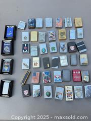 MaxSold Auction: Lot of Approximately 44 Zippo-Style Windproof Flip-Top Lighters - Los Angeles (California, USA) PARTNER MANAGED Downsizing Online Auction - W 88th Place