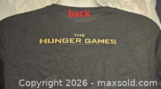 MaxSold Auction: Hunger Games t shirt  - Toronto (Ontario, Canada) SELLER MANAGED Commercial Liquidation Online Auction - Revlis Crescent