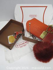 MaxSold Auction: Coach Orange/Rust Pebbled Leather Keychain with Pom Pom - Toronto (Ontario, Canada) PARTNER MANAGED Downsizing Online Auction - Research Road (STORAGE)