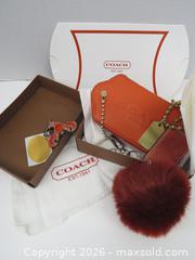 MaxSold Auction: Coach Orange/Rust Pebbled Leather Keychain with Pom Pom - Toronto (Ontario, Canada) PARTNER MANAGED Downsizing Online Auction - Research Road (STORAGE)