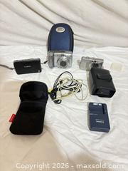 MaxSold Auction: Lot of 3 Compact Digital Cameras with Accessories - Toronto (Ontario, Canada) SELLER MANAGED Downsizing Online Auction - Rutherford Avenue