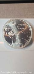 MaxSold Auction: Silver 1976 Montreal Olympic 10 dollar Coin - world Map Lot 27 - Almonte (Ontario, Canada) SELLER MANAGED Downsizing Online Auction - River Road