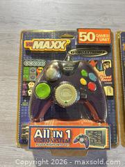 MaxSold Auction: Two new video game controllers - Cocoa (Florida, USA) SELLER MANAGED Estate Sale Online Auction - Broadcast Court.