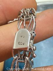 MaxSold Auction: Sterling silver charm bracelet  - Toronto (Ontario, Canada) SELLER MANAGED Downsizing Online Auction - Applefield Drive