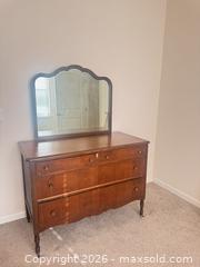 MaxSold Auction: Vintage Stained Wood Dresser with Scalloped Mirror - Raleigh (North Carolina, USA) PARTNER MANAGED Downsizing Online Auction - Fern Stone Court