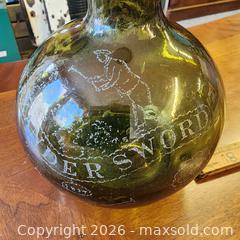 MaxSold Auction:  Alexander Sword Hand-Blown Olive Green Demijohn-Style Bottle with advertisement  - Leeds And The Thousand Islands (Ontario, Canada) SELLER MANAGED Downsizing Online Auction - Prince Street