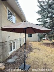 MaxSold Auction: Brown/Taupe Patio Umbrella with Base, 7–9 ft - Calgary (Alberta, Canada) SELLER MANAGED Moving Online Auction - Varsville Place Northwest