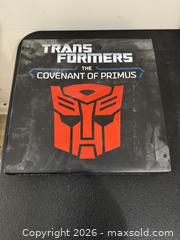 MaxSold Auction: Transformers: The Covenant of Primus hardcover book encased in an Autobot emblem with sound effects  - Marietta (Georgia, USA) PARTNER MANAGED Estate Sale Online Auction - Casteel Park Drive Southwest
