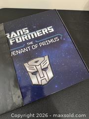 MaxSold Auction: Transformers: The Covenant of Primus hardcover book encased in an Autobot emblem with sound effects  - Marietta (Georgia, USA) PARTNER MANAGED Estate Sale Online Auction - Casteel Park Drive Southwest