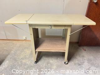 MaxSold Auction: Vintage Beige Metal Drop-Leaf Table with Drawer & Casters - Point Edward (Ontario, Canada) SELLER MANAGED Estate Sale Online Auction -  Michigan Avenue