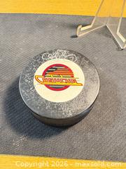 MaxSold Auction: Vancouver Canucks Signed NHL Official Trench Rubber Hockey Puck - Maple Ridge (British Columbia, Canada) PARTNER MANAGED Estate Sale Online Auction - Blanshard Street