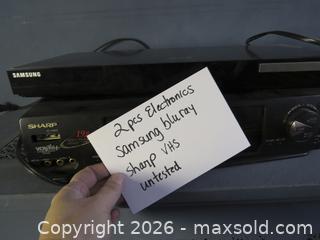 MaxSold Auction: Samsung Blu-ray/DVD Player and Sharp VCR/VHS Player, Black - Toronto (Ontario, Canada) SELLER MANAGED Downsizing Online Auction - St Edmunds Drive