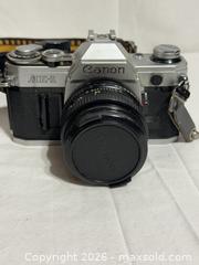MaxSold Auction: Vintage Canon AE1 135 mm SLR Film Camera Photograph  - Ottawa (Ontario, Canada) SELLER MANAGED Downsizing Online Auction - Prince Albert Street