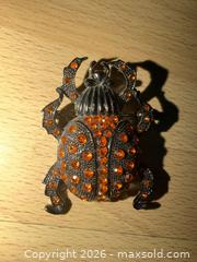 MaxSold Auction: 2” black decorative brooch designed to look like a scarab beetle w orange rhinestones  - Warwick Township (Pennsylvania, USA) SELLER MANAGED Estate Sale Online Auction - Crocker Lane