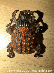MaxSold Auction: 2” black decorative brooch designed to look like a scarab beetle w orange rhinestones  - Warwick Township (Pennsylvania, USA) SELLER MANAGED Estate Sale Online Auction - Crocker Lane