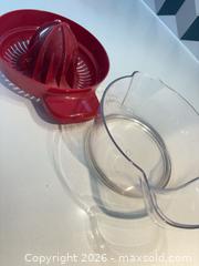 MaxSold Auction: Red/Clear Plastic Manual Citrus Juicer with Measuring Cup - Toronto (Ontario, Canada) SELLER MANAGED Downsizing Online Auction - Poplar Plains Road