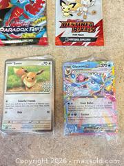 MaxSold Auction: New! Pokémon Trading Card Lot: Booster Packs, Single Cards, Stickers - Welland (Ontario, Canada) SELLER MANAGED Reseller Online Auction - Young Road