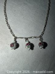 MaxSold Auction: PRETTY 15” SILVER TONE NECKLACE WITH 3 WHITE FLORAL CERAMIC CHARMS  - Warwick Township (Pennsylvania, USA) SELLER MANAGED Estate Sale Online Auction - Crocker Lane