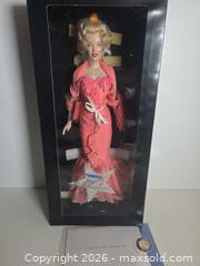 MaxSold Auction: Franklin Mint Marilyn Monroe Collector Doll, 16 in, Coral Outfit - Lakeland (Florida, USA) PARTNER MANAGED Downsizing Online Auction - Shore Acres Drive