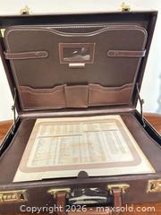 MaxSold Auction: Brown Faux Leather Briefcase with Combination Locks - Wake Forest (North Carolina, USA) PARTNER MANAGED Downsizing Online Auction - Wait Avenue