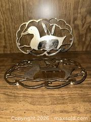 MaxSold Auction: Set of 2 vintage metal hot plate trivets  - Wake Forest (North Carolina, USA) PARTNER MANAGED Downsizing Online Auction - Wait Avenue