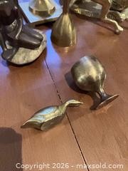 MaxSold Auction: Mixed metal lot: brass & bronze candlesticks, figurines, bell (8 pcs) - Coquitlam (British Columbia, Canada) SELLER MANAGED Reseller Online Auction - Robson Drive