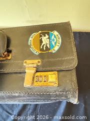 MaxSold Auction: Leather Travel Briefcase with Pilot Cap and Adhered Collectible Stickers  - Delaware City Township (Ohio, USA) PARTNER MANAGED Downsizing Online Auction - Hillside Drive