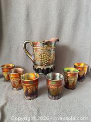 MaxSold Auction: Northwood Amethyst Grape and Cable Carnival Glass Pitcher with Six Tumblers - Bremerton (Washington, USA) SELLER MANAGED Estate Sale Online Auction - Burwell Street