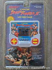 MaxSold Auction: Dream Cast Controllers, Device and Street Fighter II LCD Video Game Capcom  - Los Angeles (California, USA) PARTNER MANAGED Moving Online Auction - W 36th Street (CONDO)