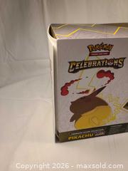 MaxSold Auction: Pokemon Celebrations Pikachu VMAX Figure & Trading Cards - Toronto (Ontario, Canada) SELLER MANAGED Downsizing Online Auction - Rutland Street